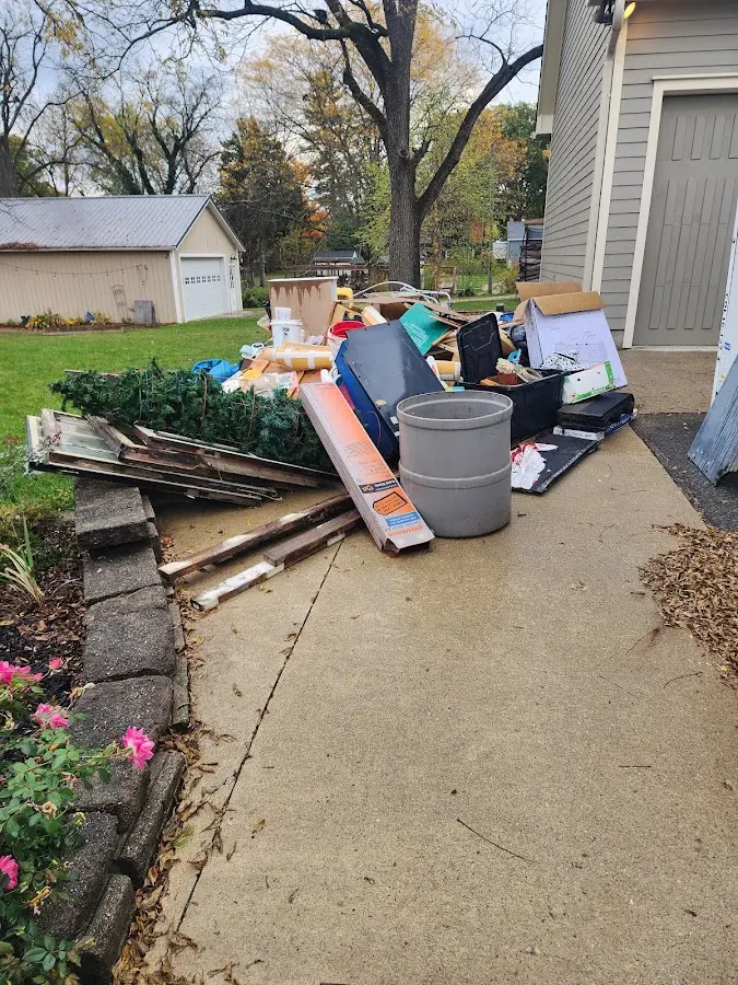 Dumpster being loaded with debris for Residential Dumpster Rental in Brookhaven
